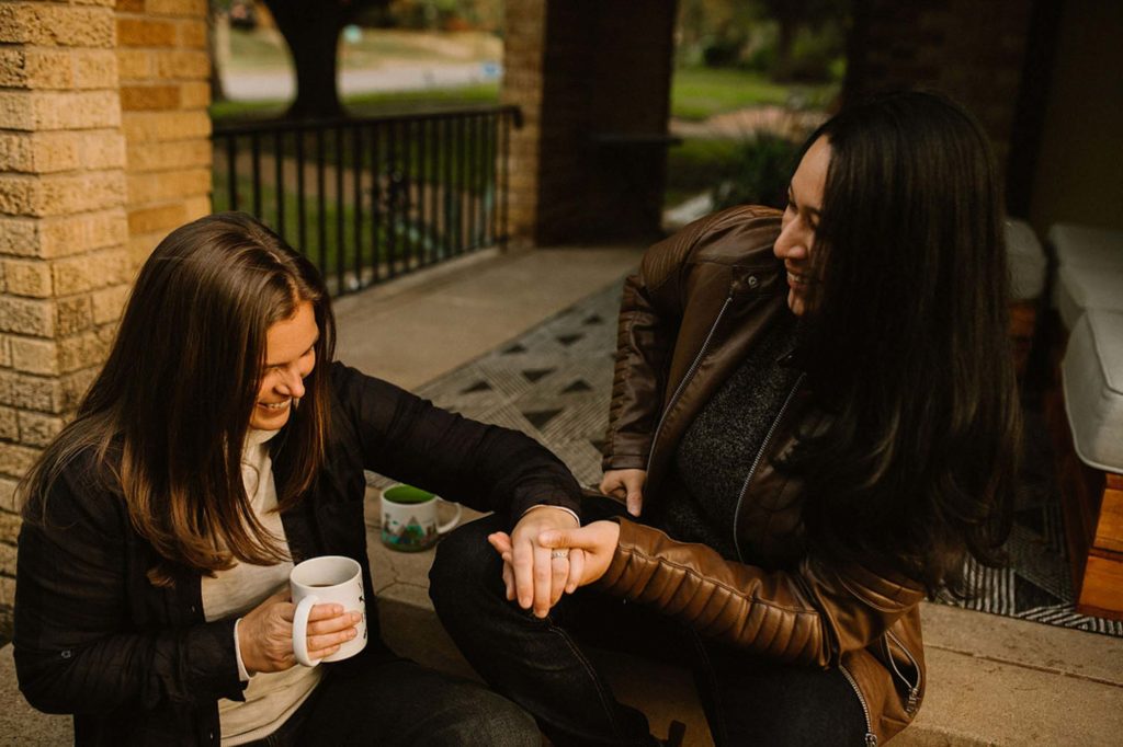 Cozy at home proposal with coffee and kisses | Whitney Rogers Photography | Featured on Equally Wed, the leading LGBTQ+ wedding magazine - coffee, leather jackets, home