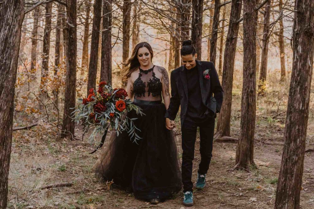 Oklahoma elopement in the Wichita Mountains with enchanting all black attire | Brooke Lewis Photography | Featured on Equally Wed, the leading LGBTQ+ wedding magazine - - forest, mountains, black attire, pride flag