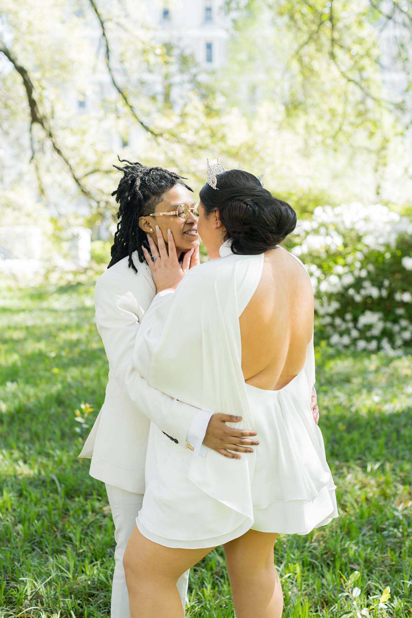Sunny South Carolina elopement surrounded by greenery | Jessica Hunt Photography | Featured on Equally Wed, the leading LGBTQ+ wedding magazine - white tux, cut out dress, tiara, crown, gold rimmed glasses, first look