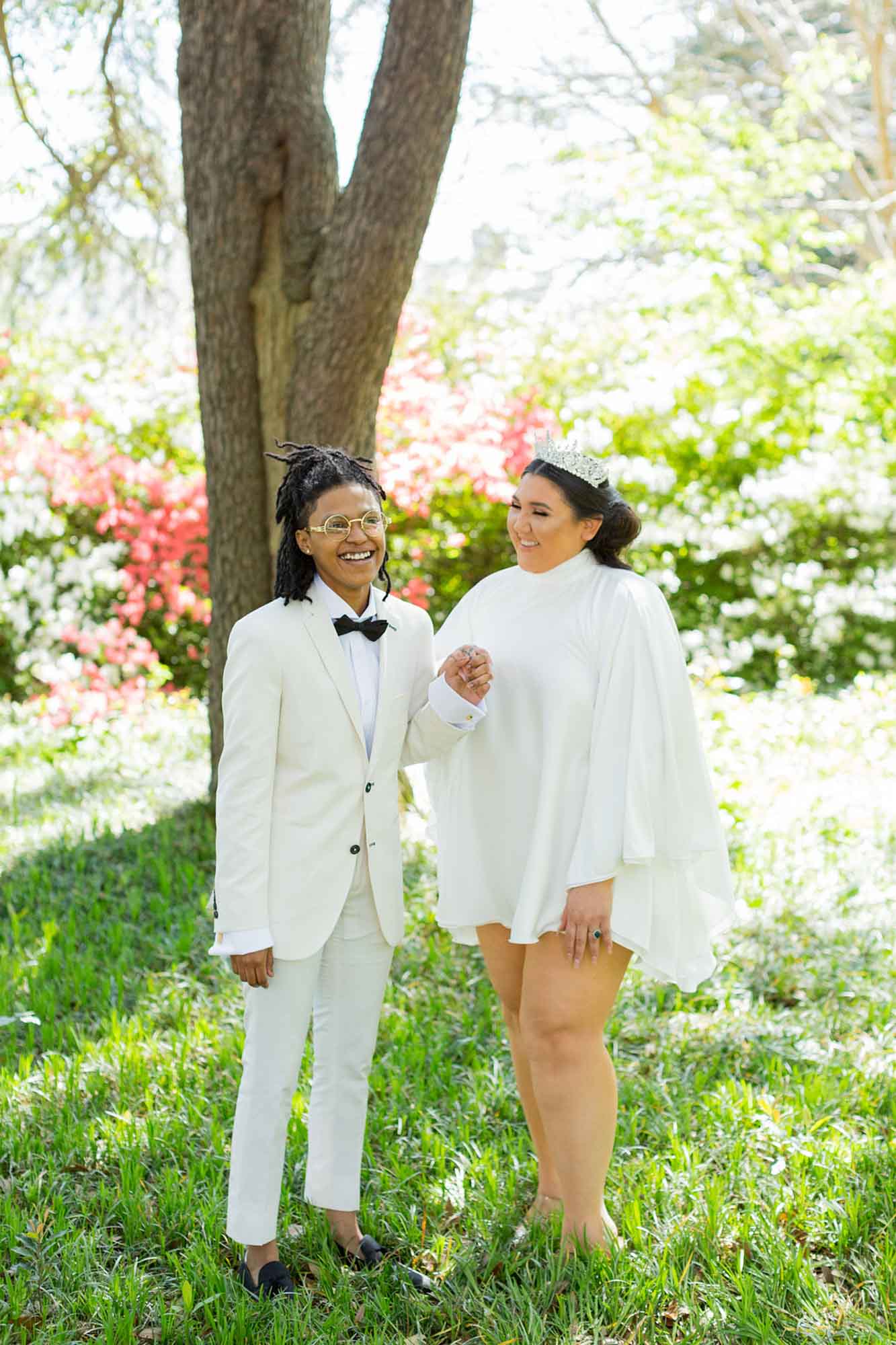 Sunny South Carolina elopement surrounded by greenery | Jessica Hunt Photography | Featured on Equally Wed, the leading LGBTQ+ wedding magazine - white tux, cut out dress, tiara, crown, gold rimmed glasses