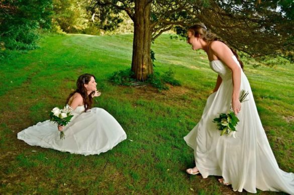 These lesbian brides accidentally wore the same dress. The first look photos are priceless | Sarah Smith Studios | Featured on Equally Wed, the leading LGBTQ+ wedding magazine - mountain, sunset, white dress, green suit