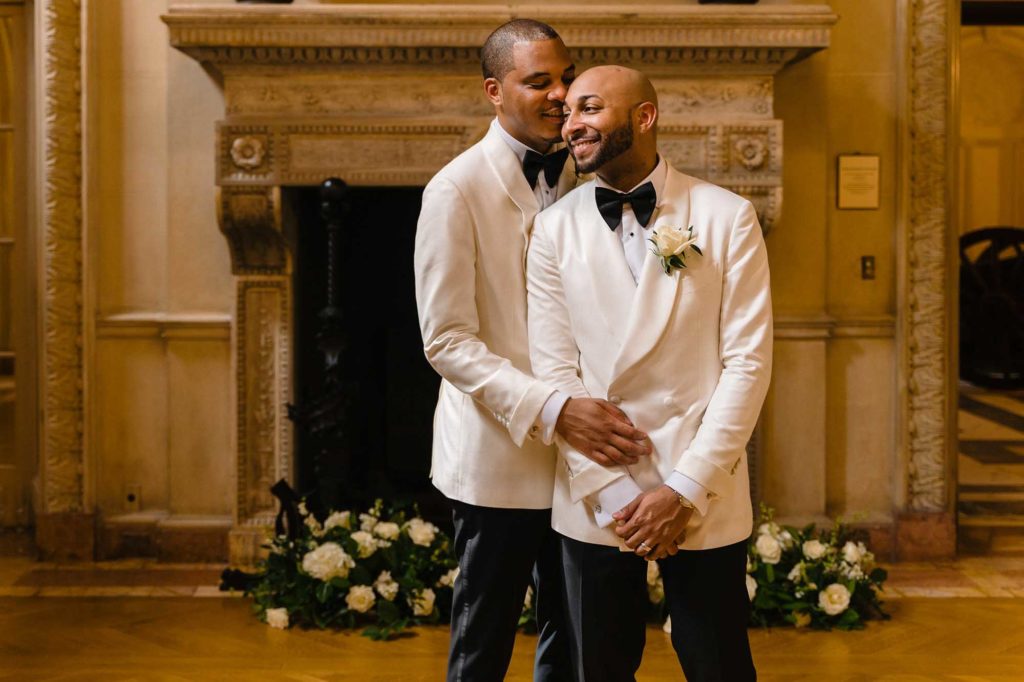 This couple transformed their home into a fabulous wedding venue | Myron Fields Photography | Featured on Equally Wed, the leading LGBTQ+ wedding magazine - grooms, white tuxedo