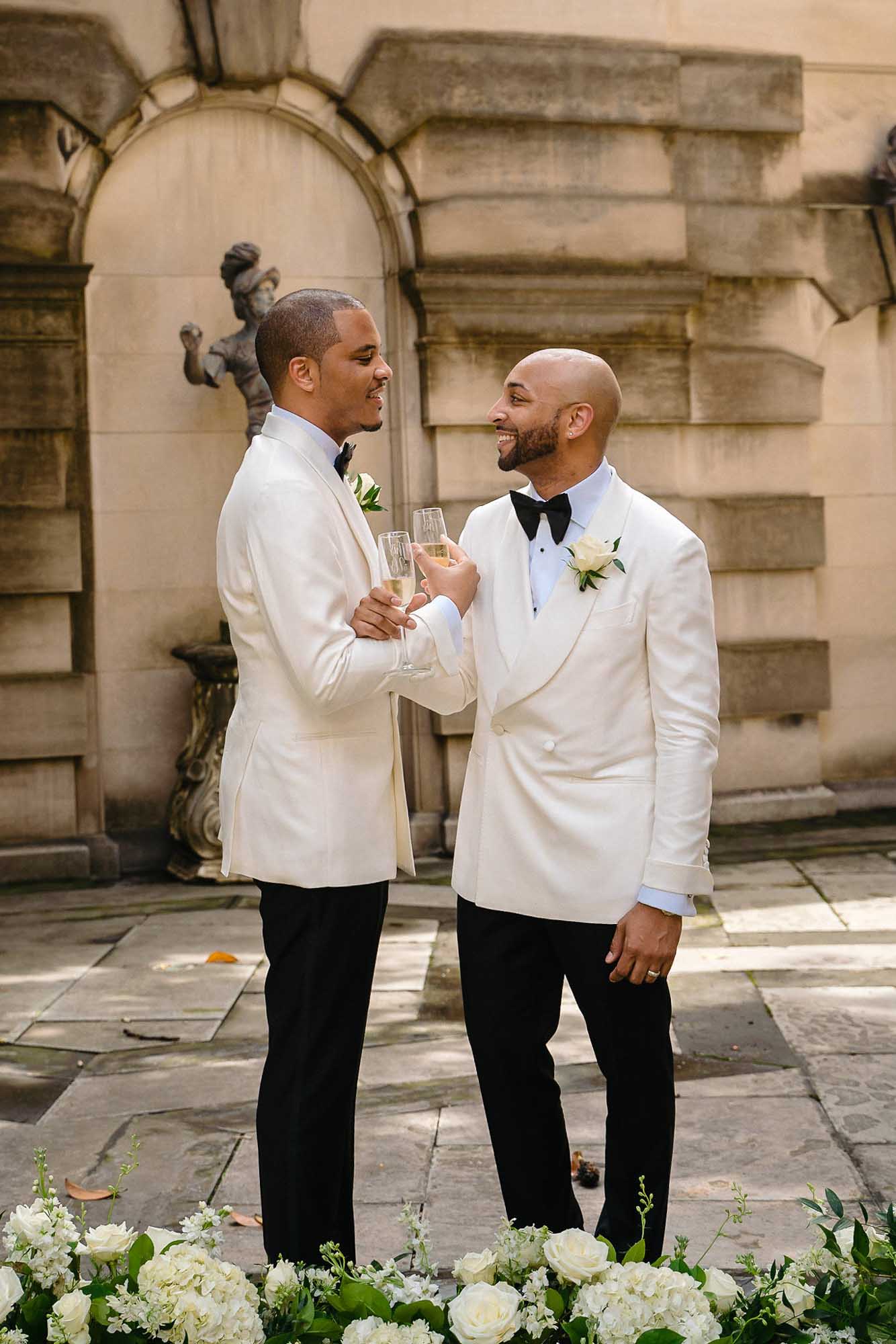 This couple transformed their home into a fabulous wedding venue | Myron Fields Photography | Featured on Equally Wed, the leading LGBTQ+ wedding magazine - grooms, white tuxedos 