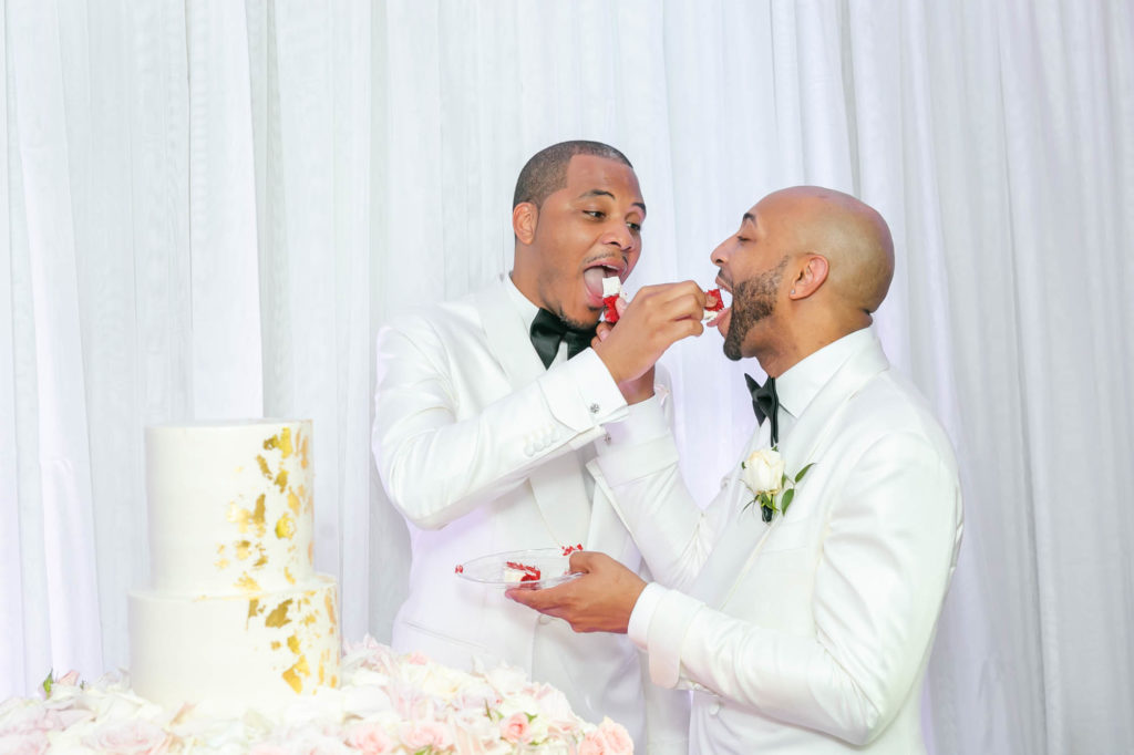 This couple transformed their home into a fabulous wedding venue | Sarandipity Photography | Featured on Equally Wed, the leading LGBTQ+ wedding magazine - grooms, white tuxedo, cake