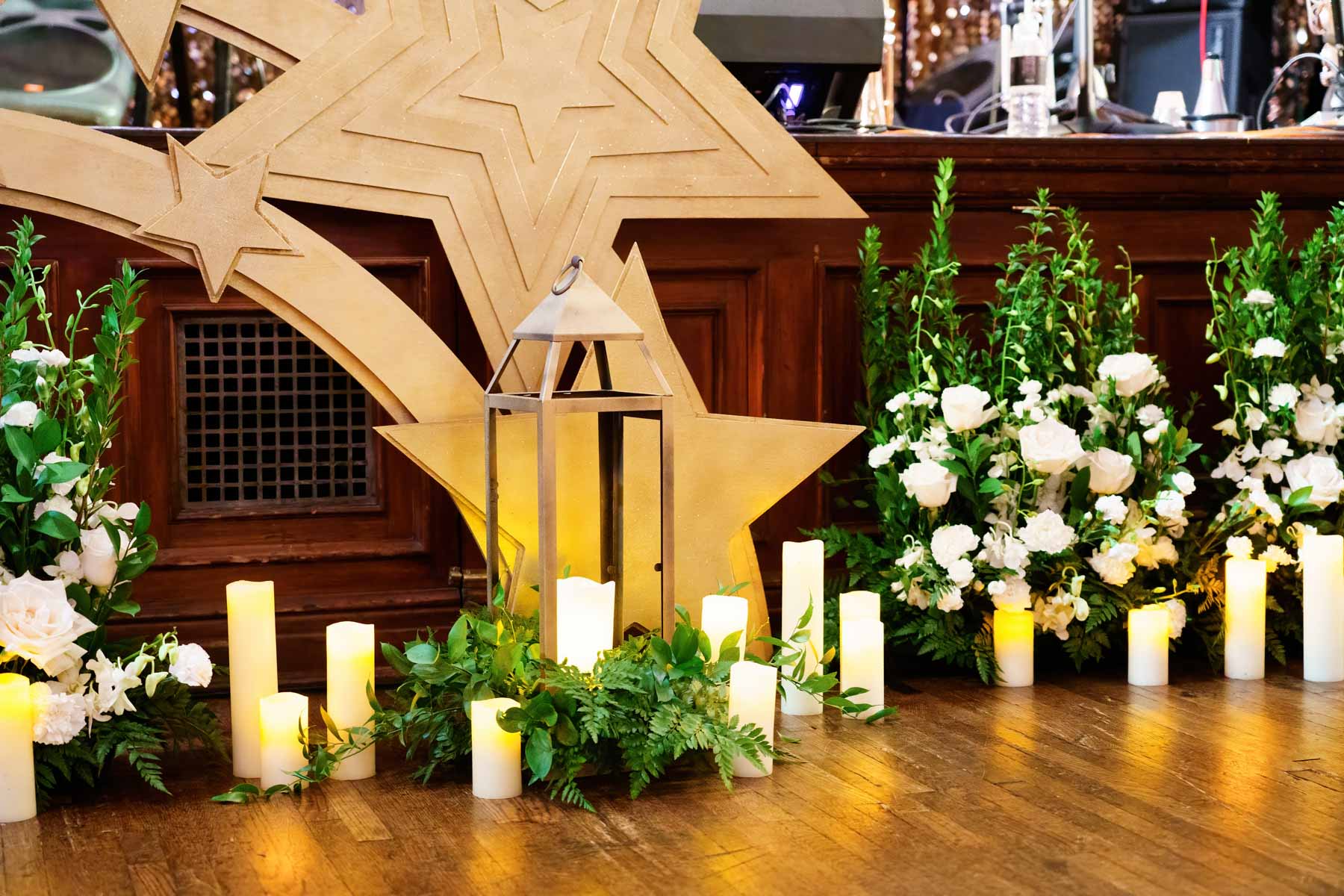 gold stars, candles, white flowers and greenery for a gay Hollywood wedding