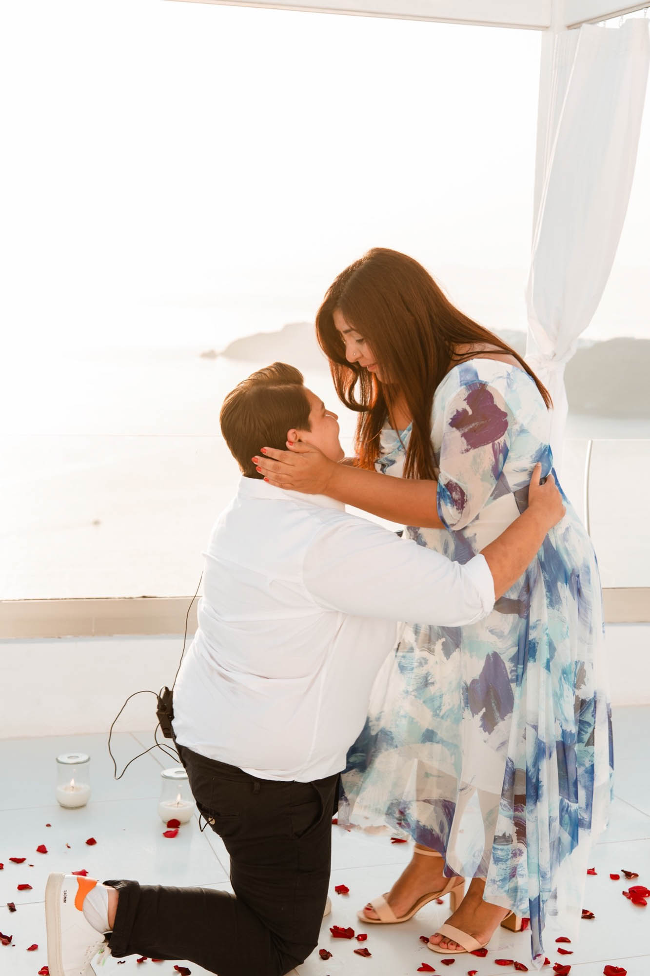 Breathtaking Santorini proposal with rose petals and a heart made of candles | Santorini Proposals | Featured on Equally Wed, the leading LGBTQ+ wedding magazine