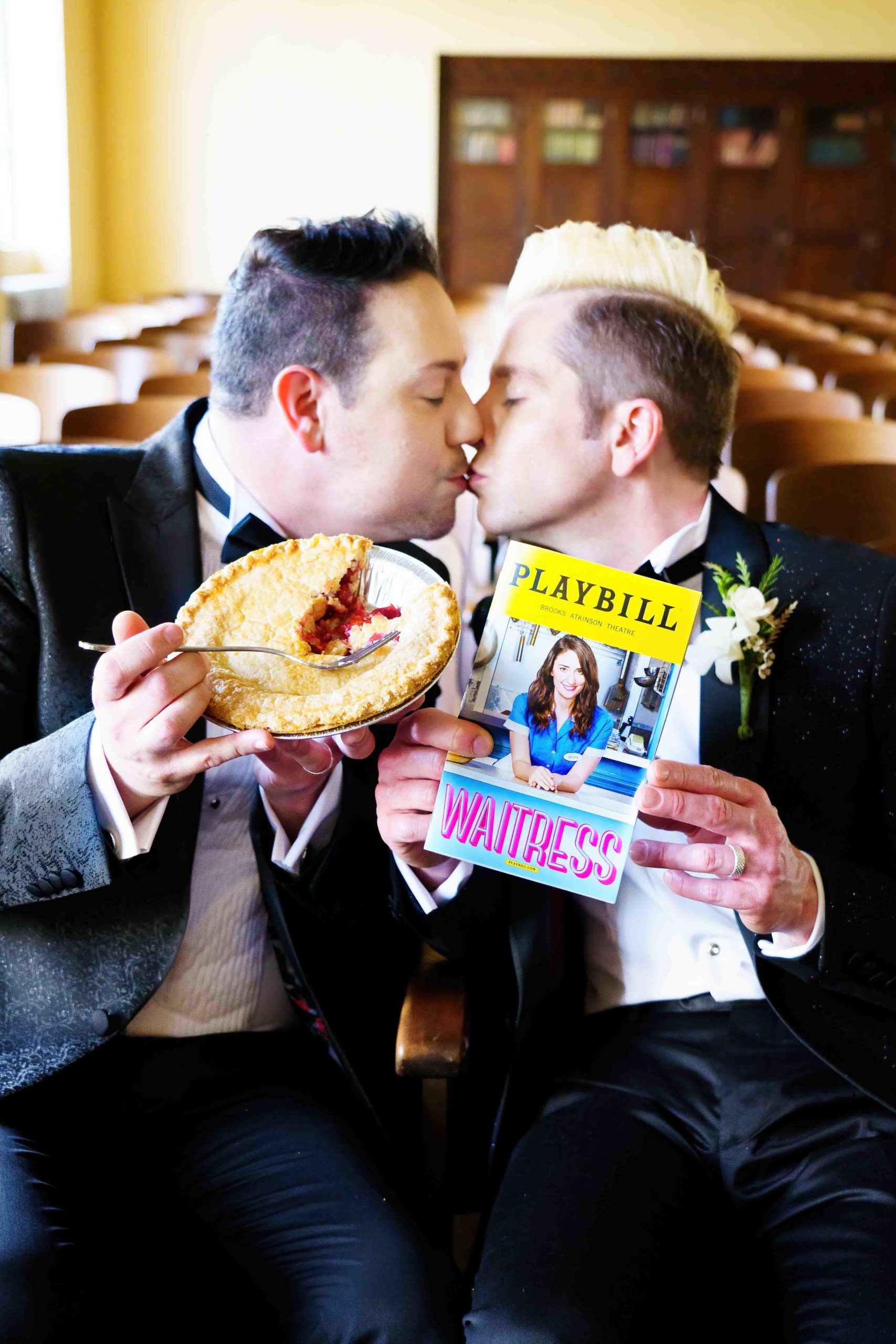 gay Hollywood wedding couple kiss while holding Waitress playbill and pie