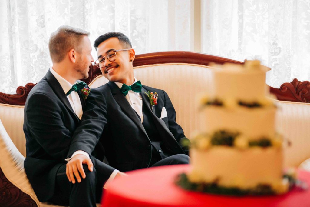 two grooms in love relax on sofa