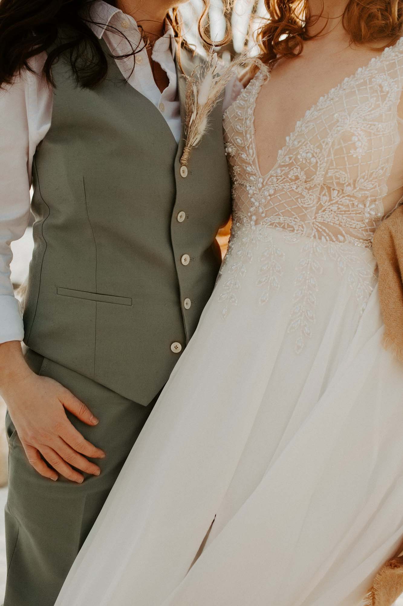 close up of suit and wedding dress
