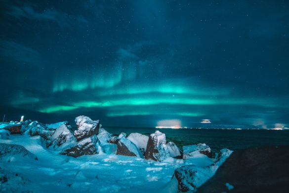 northern lights seen over snowy landscape in Iceland