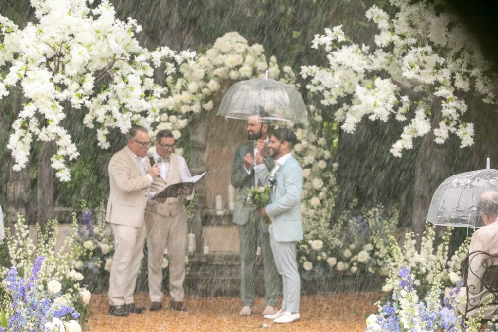 gay grooms getting married in the rain