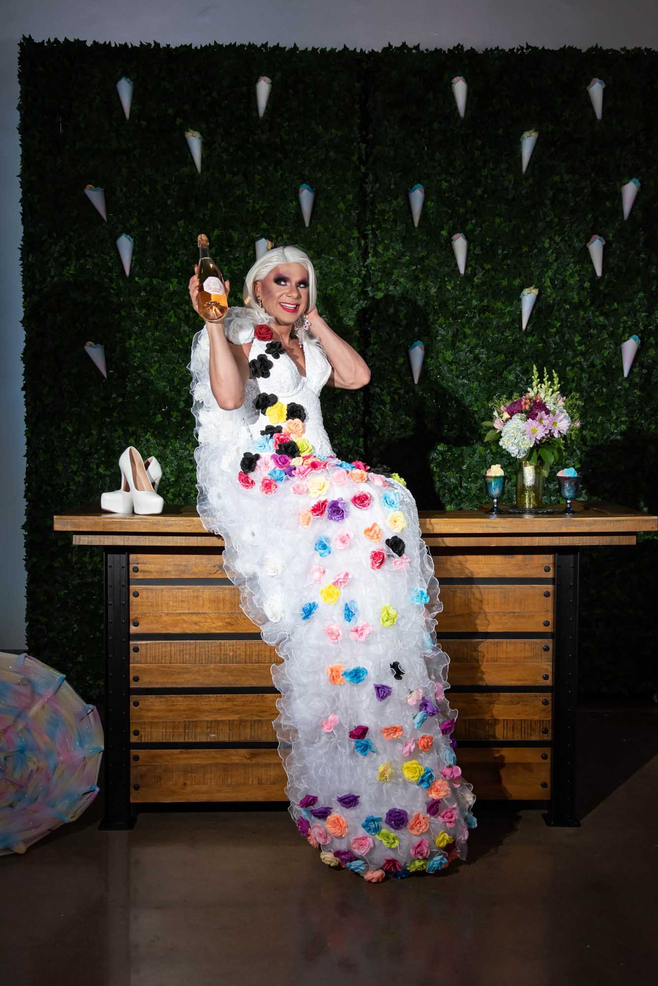 Floral gown, drag queen wedding, cotton candy wall, green wall, train in front