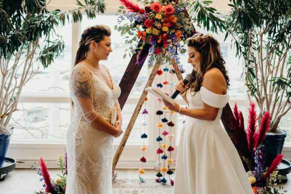 LGBTQ+ wedding of two female-presenting marriers in white wedding gowns