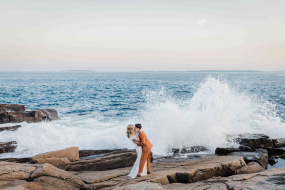 LGBTQ+ newlyweds kiss at the ocean
