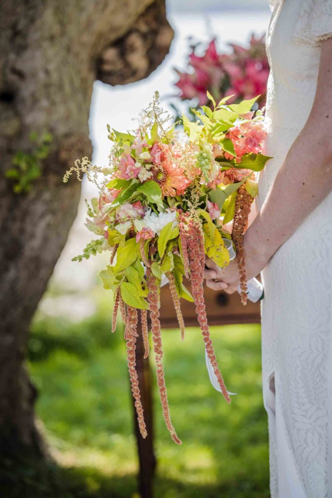 Summer wedding bouquet with pink flowers and green leaves