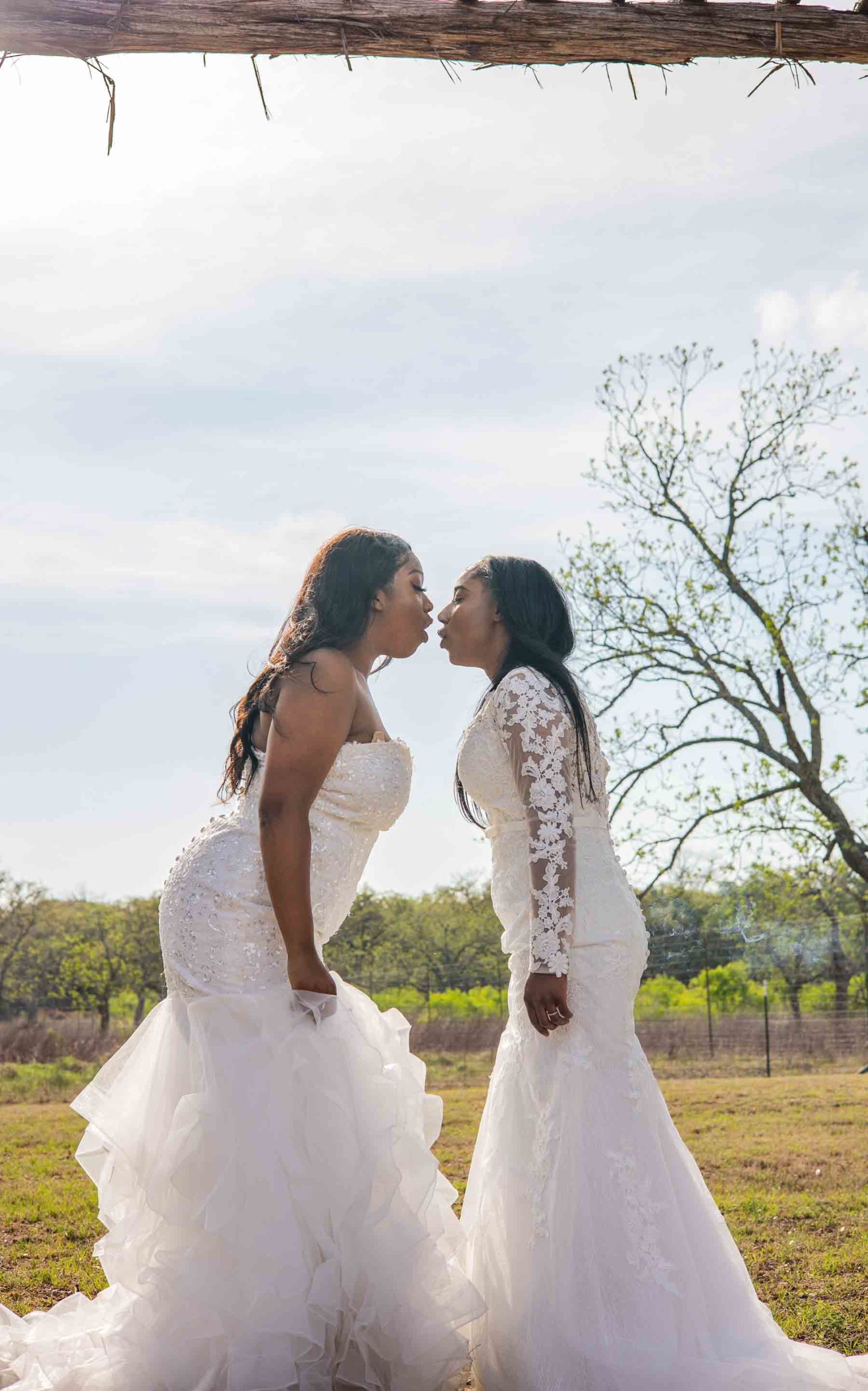 two Black lesbian brides shotgun weed smoke during wedding ceremony