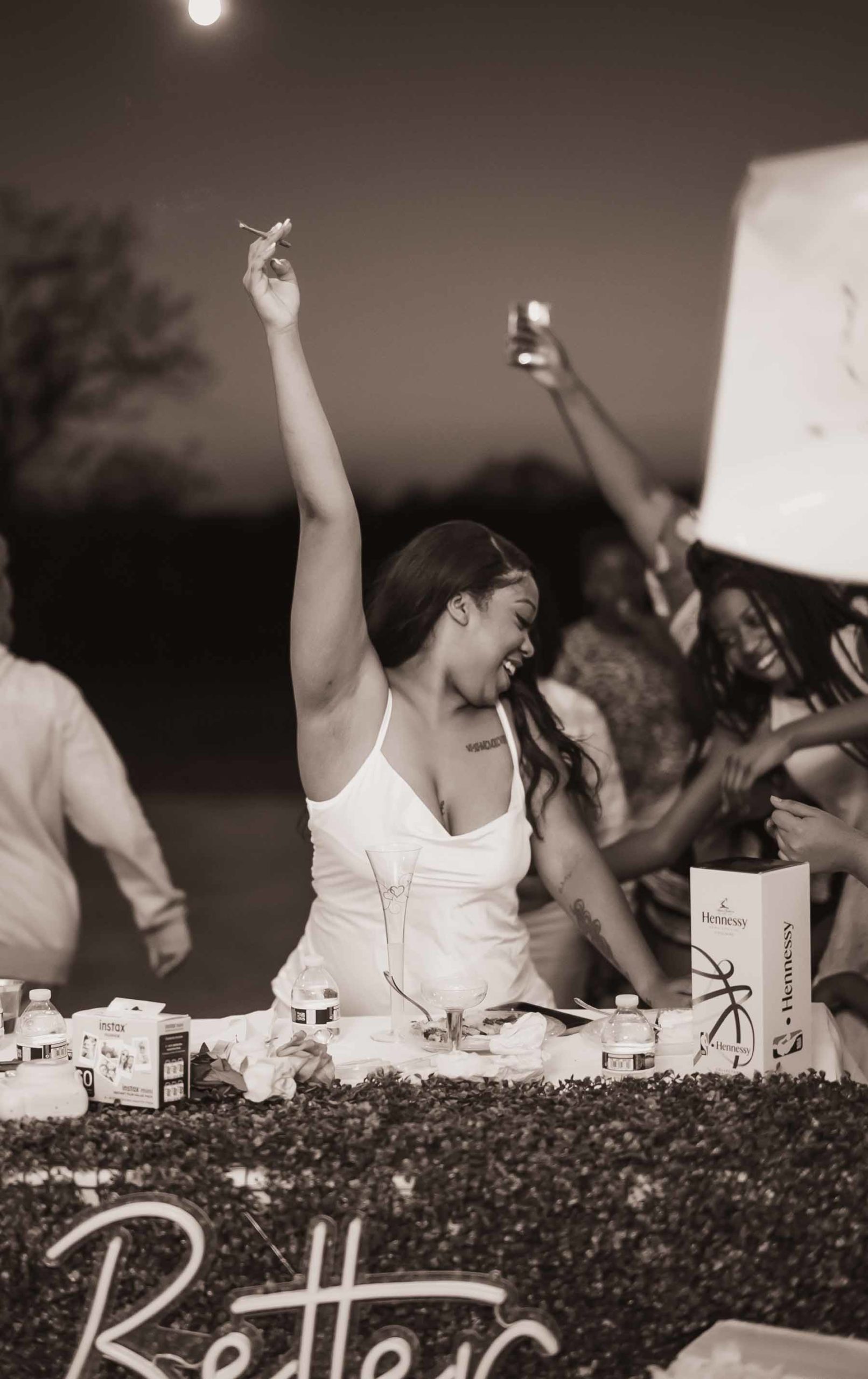black and white photo of Black bride holding up a blunt at a weed wedding