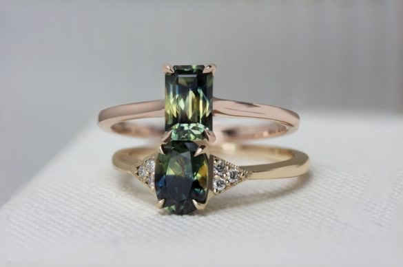 two gold wedding rings with green colored gemstones from Emily Chelsea Jewelry