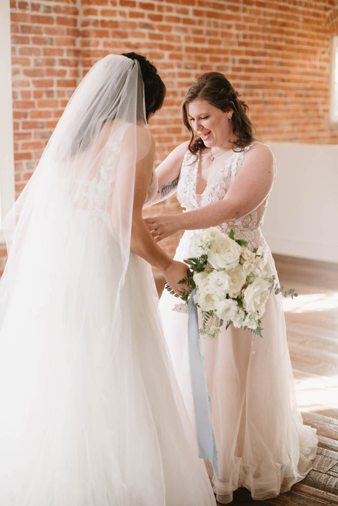 two brides share their first look before their winter wedding