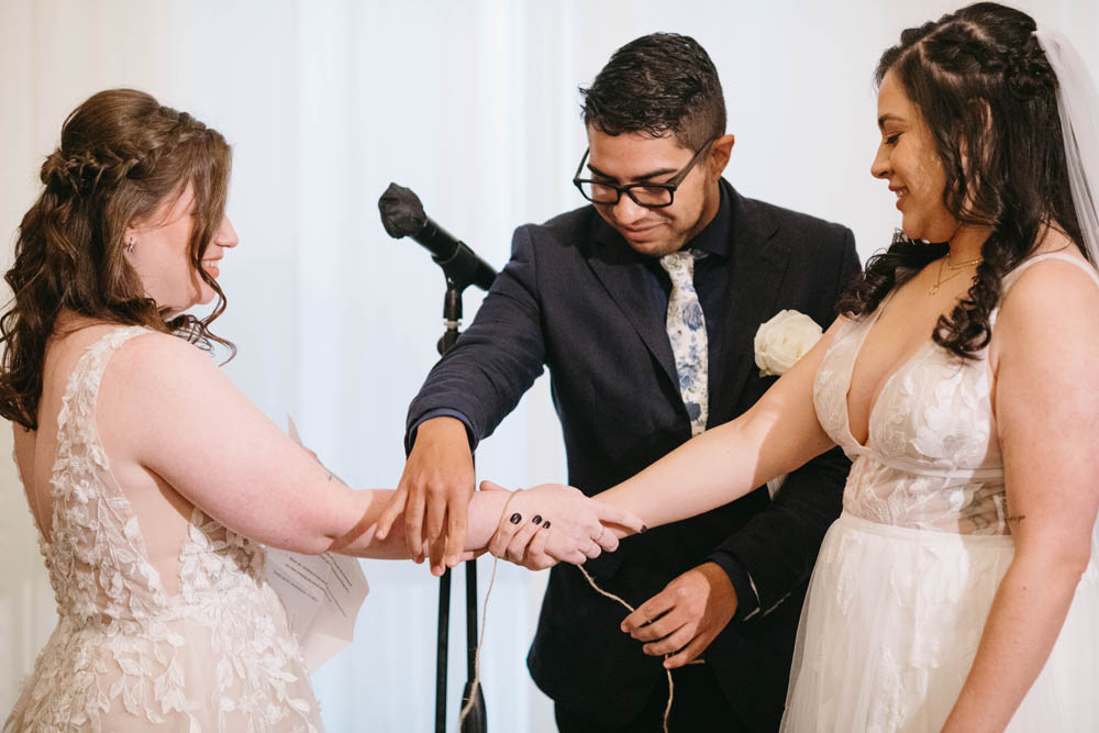 two brides marrying with handfasting in ceremony
