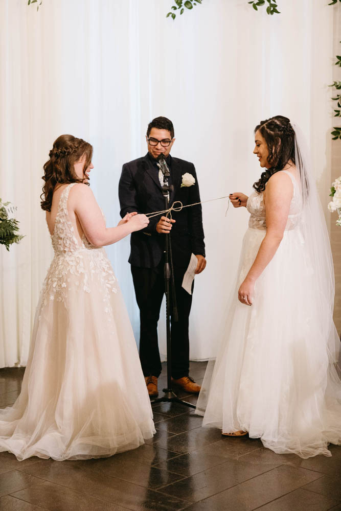 two brides marrying with handfasting in ceremony