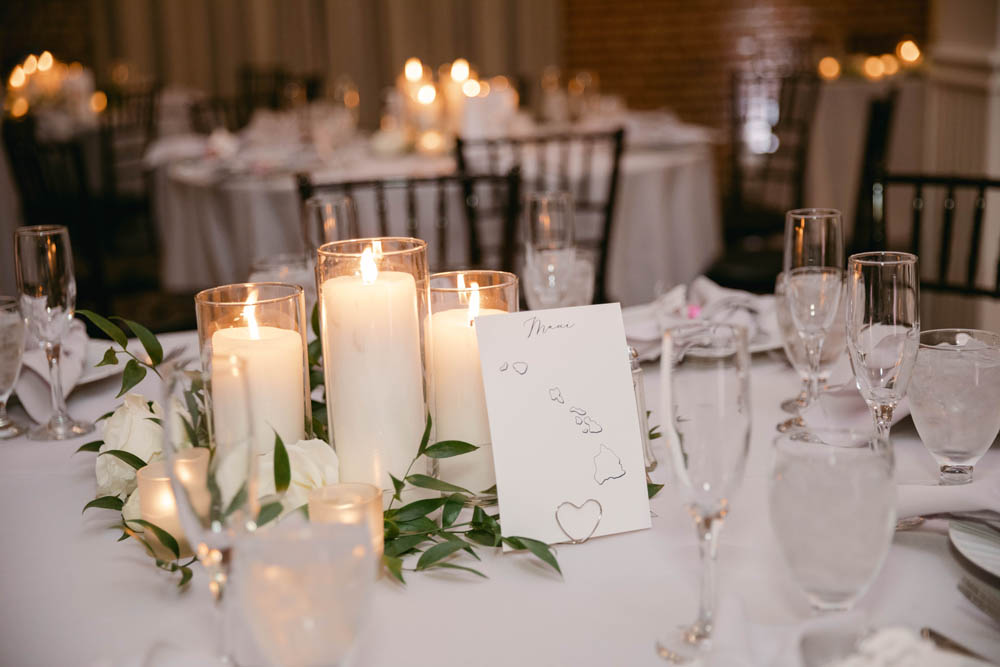 white linen table with white candles at winter wedding