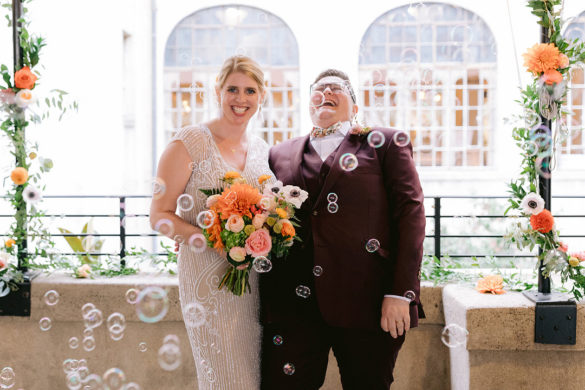 two white gay brides surrounded by bubbles