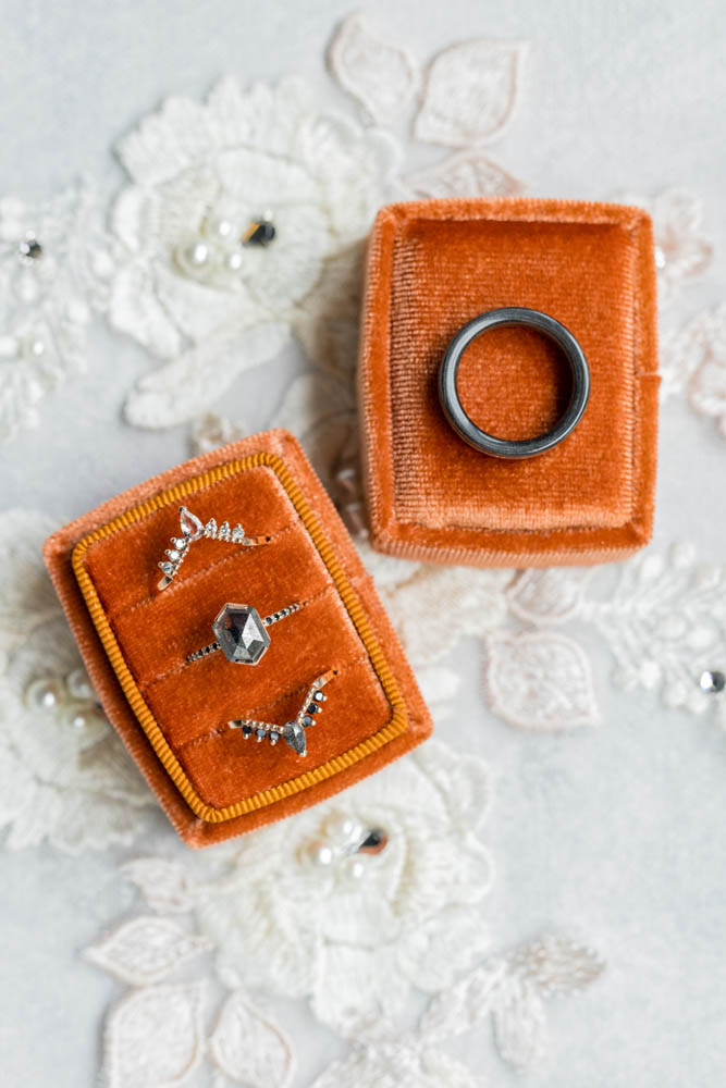 wedding rings for nonbinary, queer couple in orange ring boxes