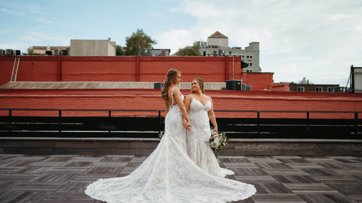 A New Orleans wedding with elegant blush pink details, lace wedding gowns and a second line