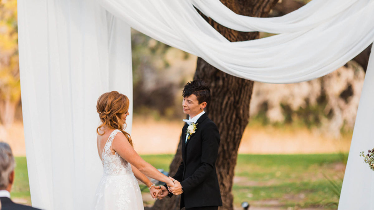 An Austin, Texas, outdoor fall wedding with lush greenery and wood finishes