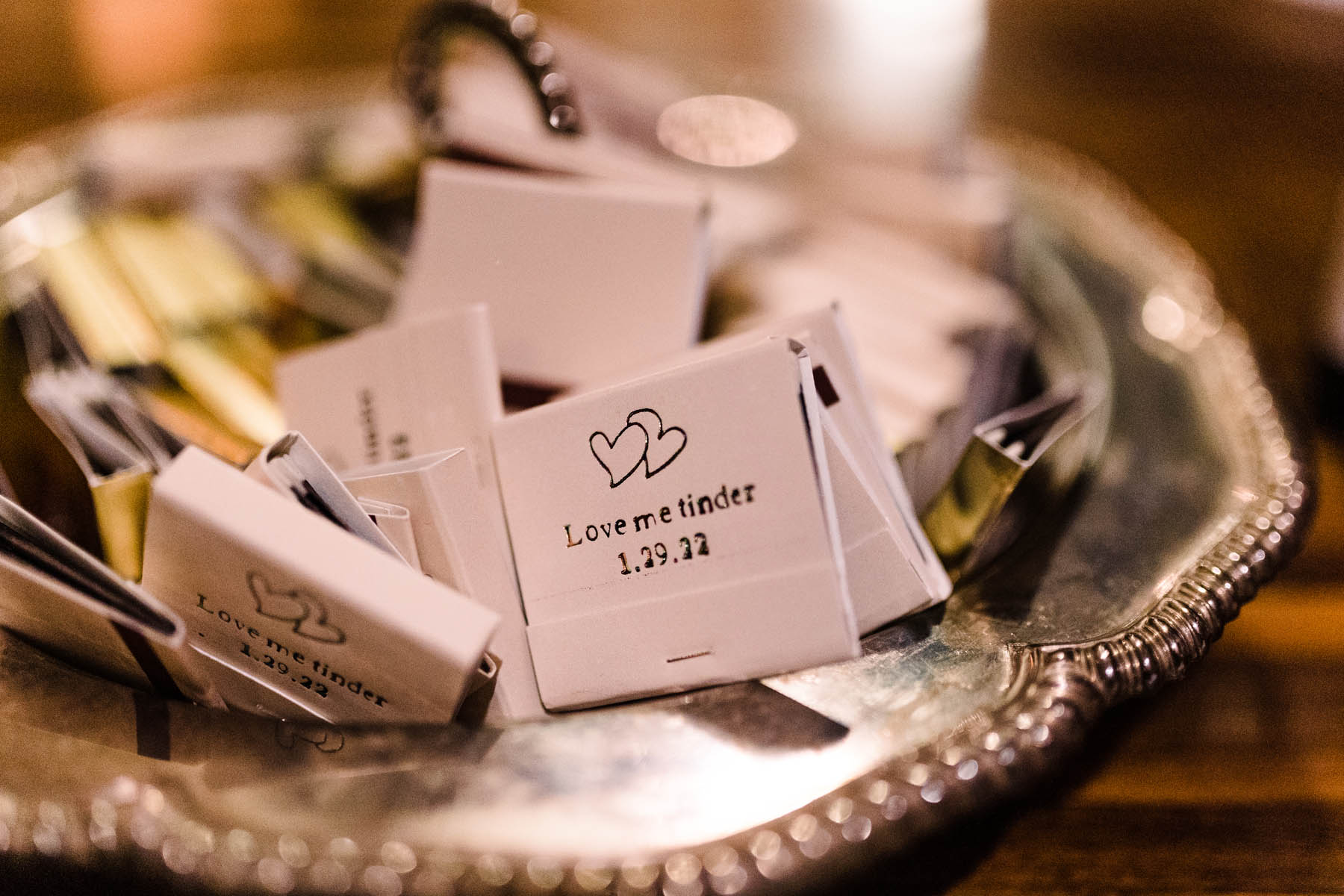 A bowl of white matchbooks that read, "love me Tinder"