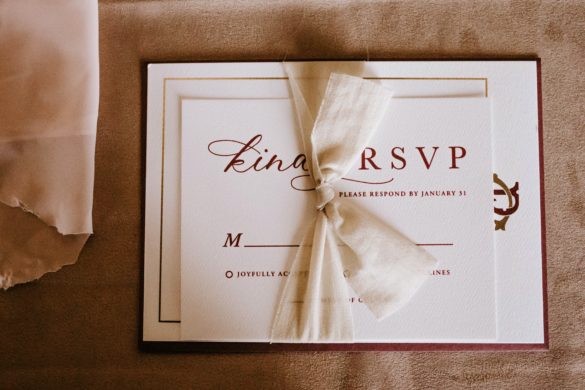 An invitation suite lays on a table.