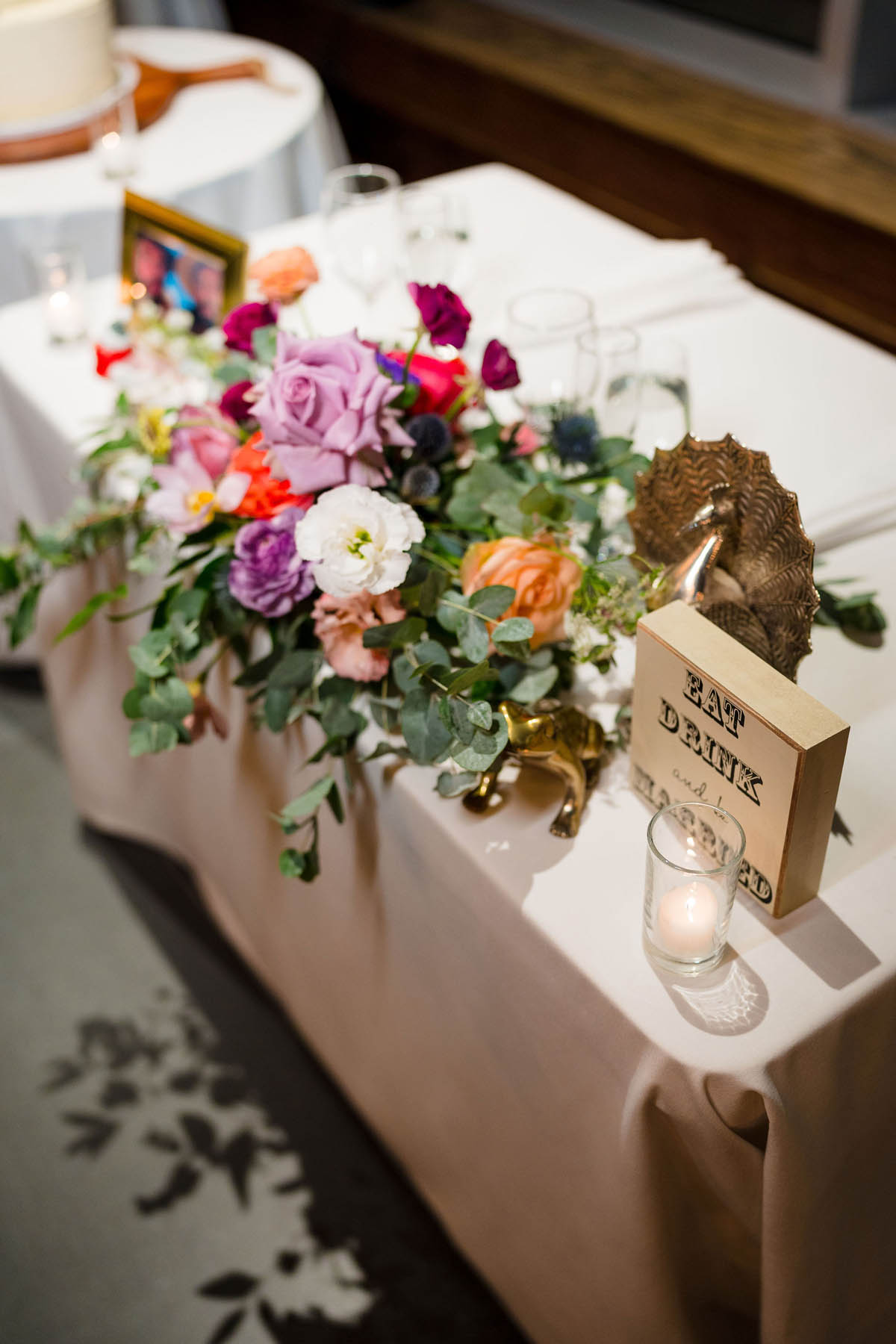 A memorial table with a white tablecloth and flowers.