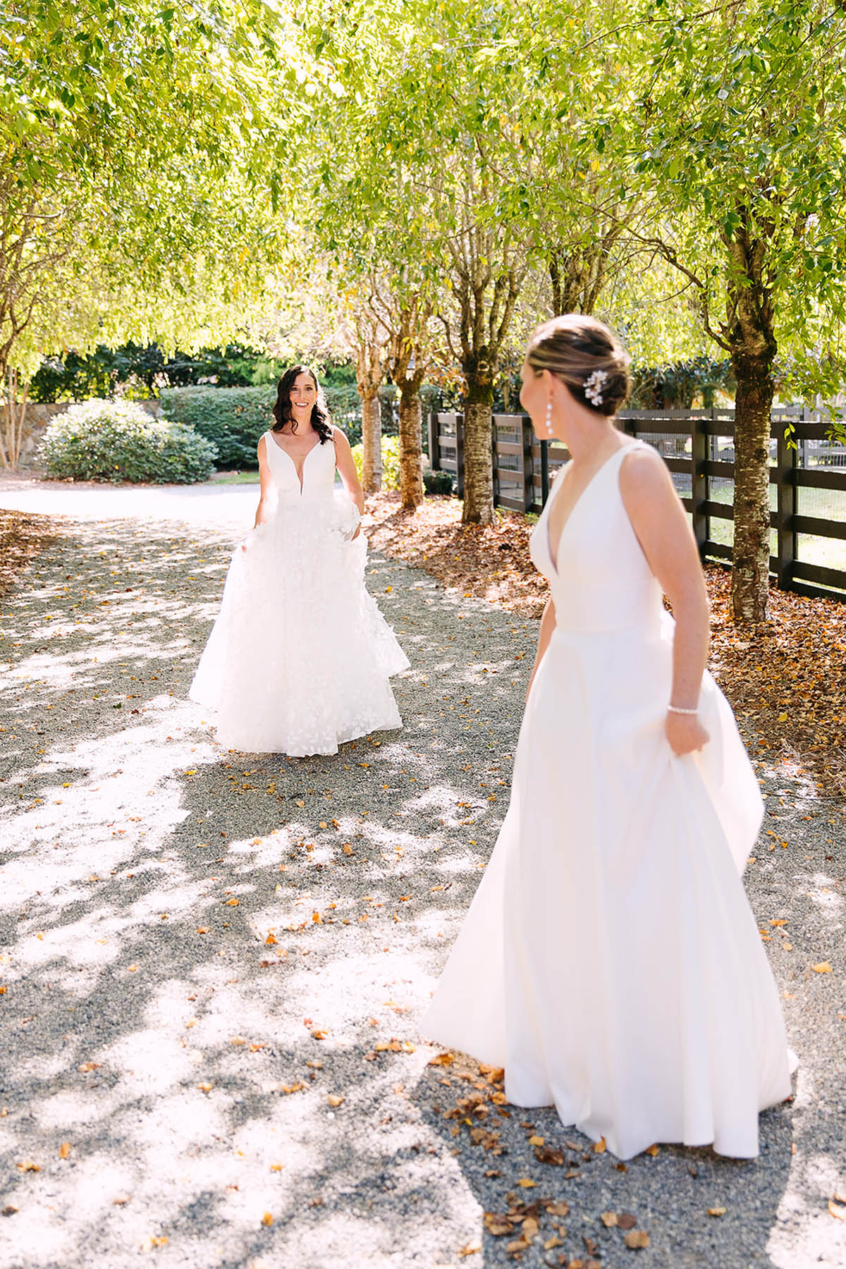 Two brides turn to see each other for a first look.