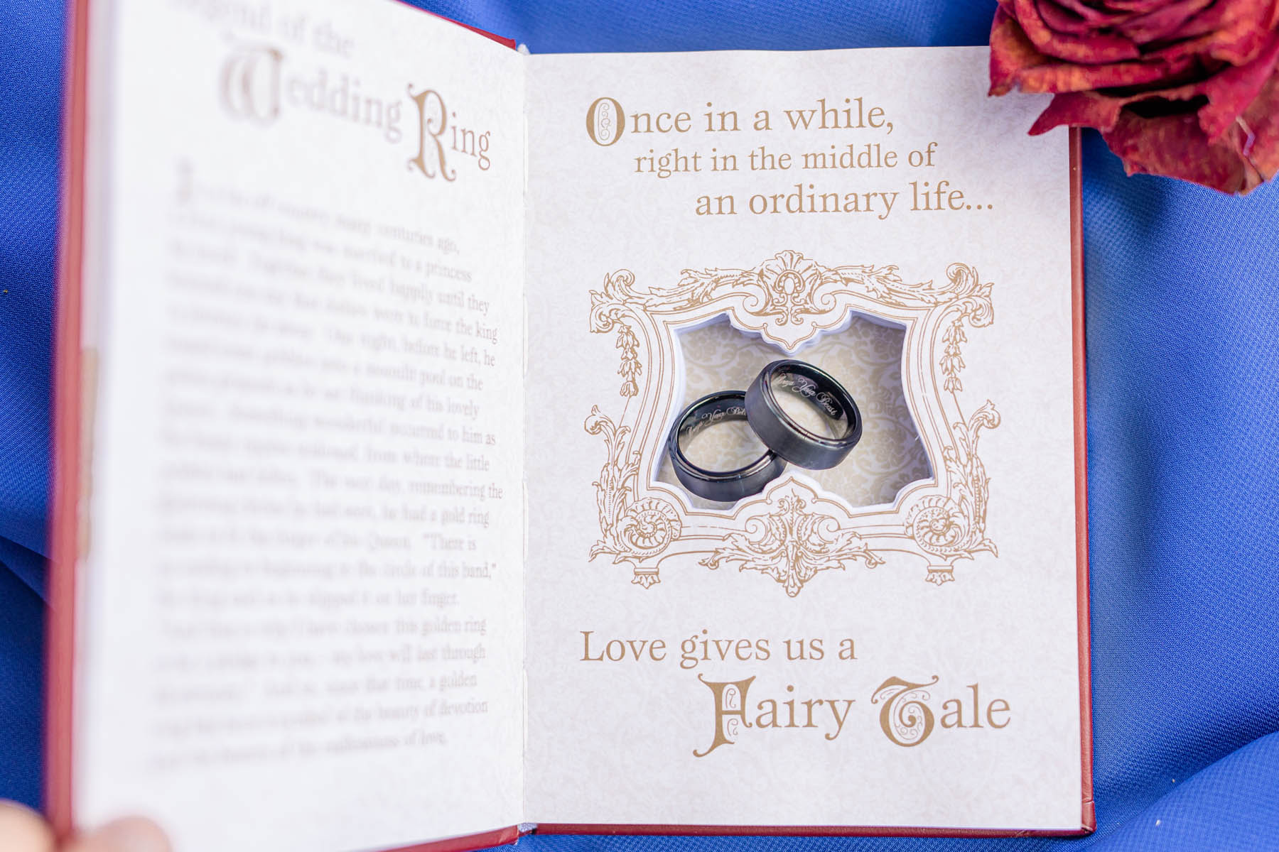 A hardcover book with two rings in the center of it. The text reads: Once in a while, right in the middle of an ordinary life... Love gives us a Fairy Tale.