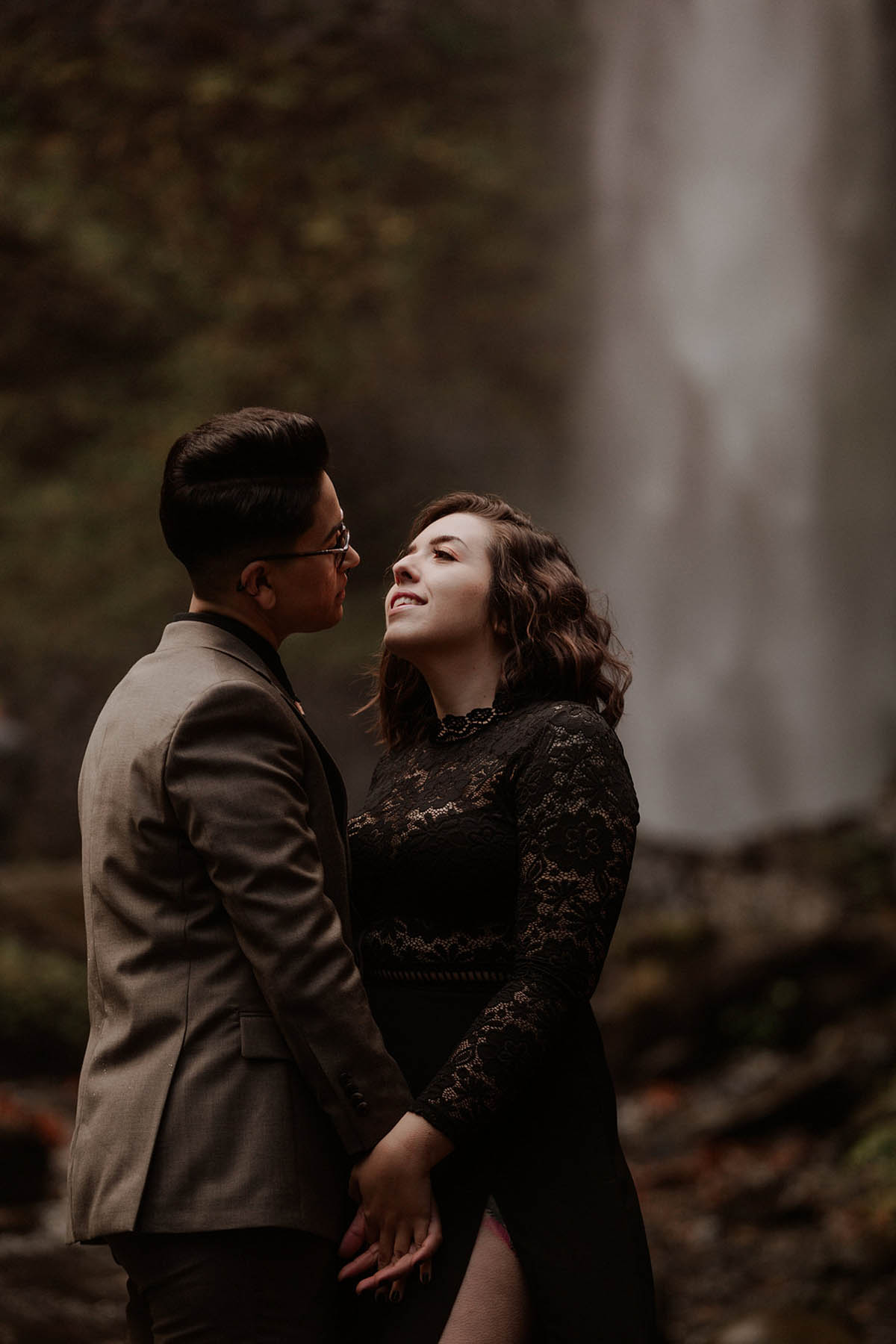 Dark-and-moody photoshoot turns into romantic proposal at the base of a waterfall