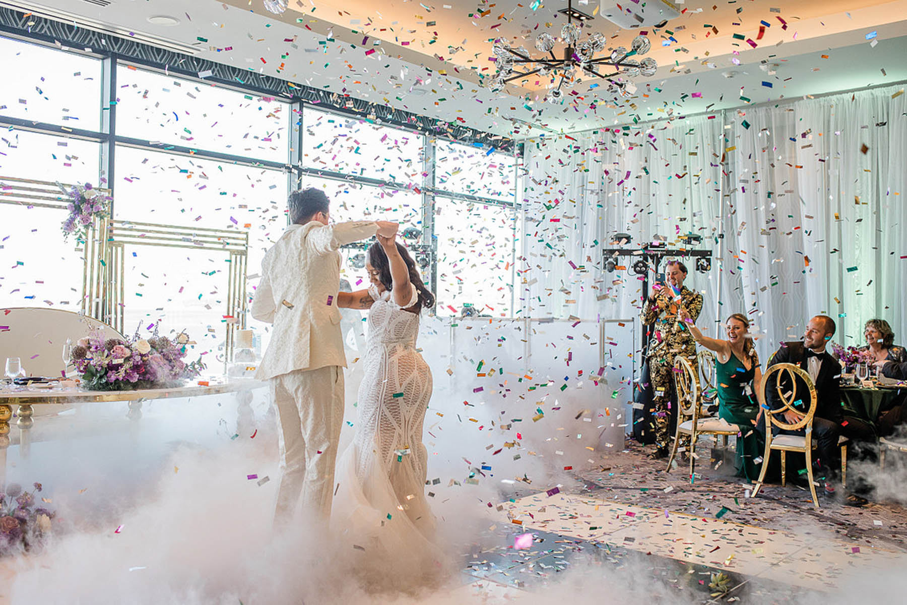 The marriers dance together in a mist of manufactured fog and confetti 