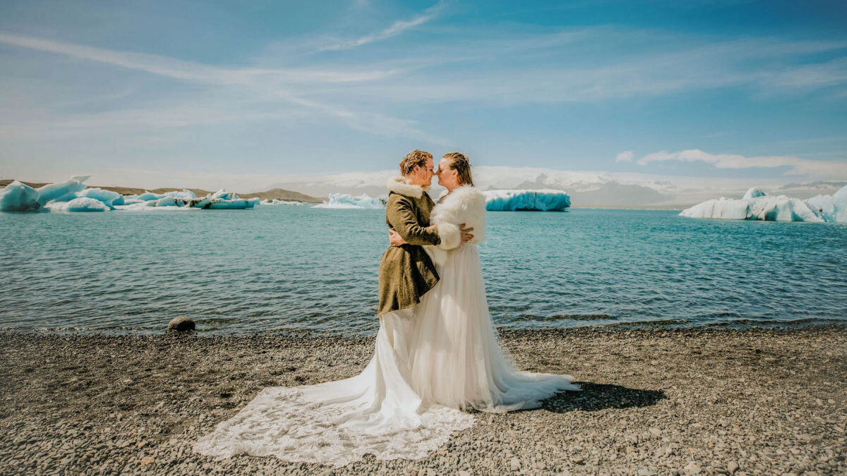 A destination elopement in Iceland with freshly picked blue lupine bouquets for pansexual brides