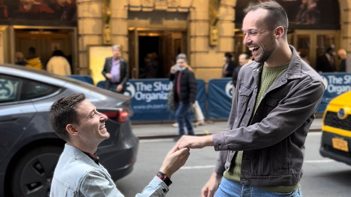A scavenger hunt Broadway proposal and surprise engagement party in Central Park for a theater-loving gay couple