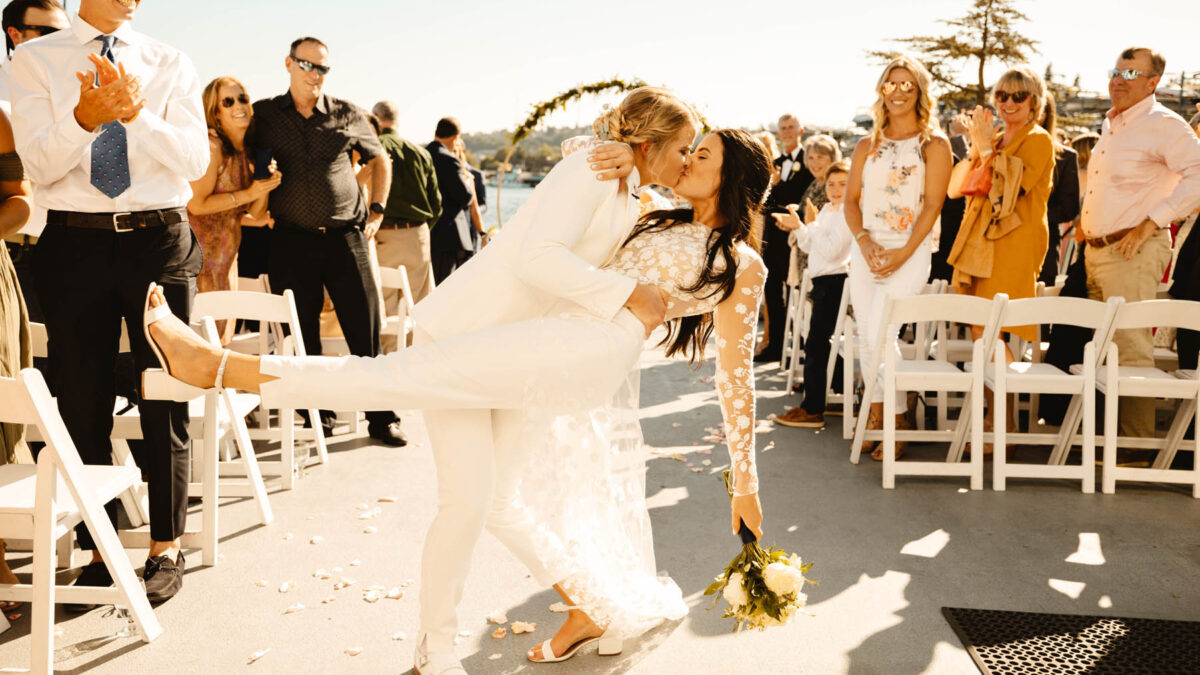These two brides had their queer Christian wedding on the Seattle waterfront with nautical vibes and a rainbow cake