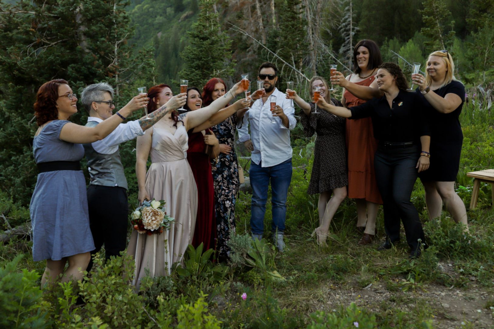 Wedding party and guests toast to the happy couple