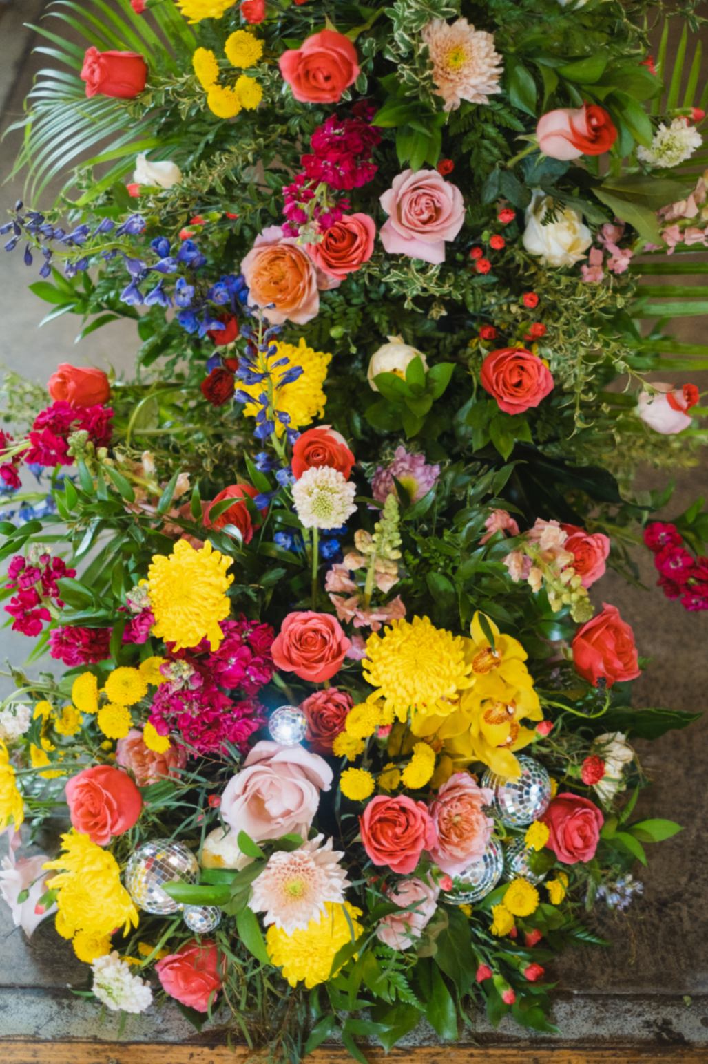 Colorful floral arrangement with mini disco balls for queer wedding inspiration