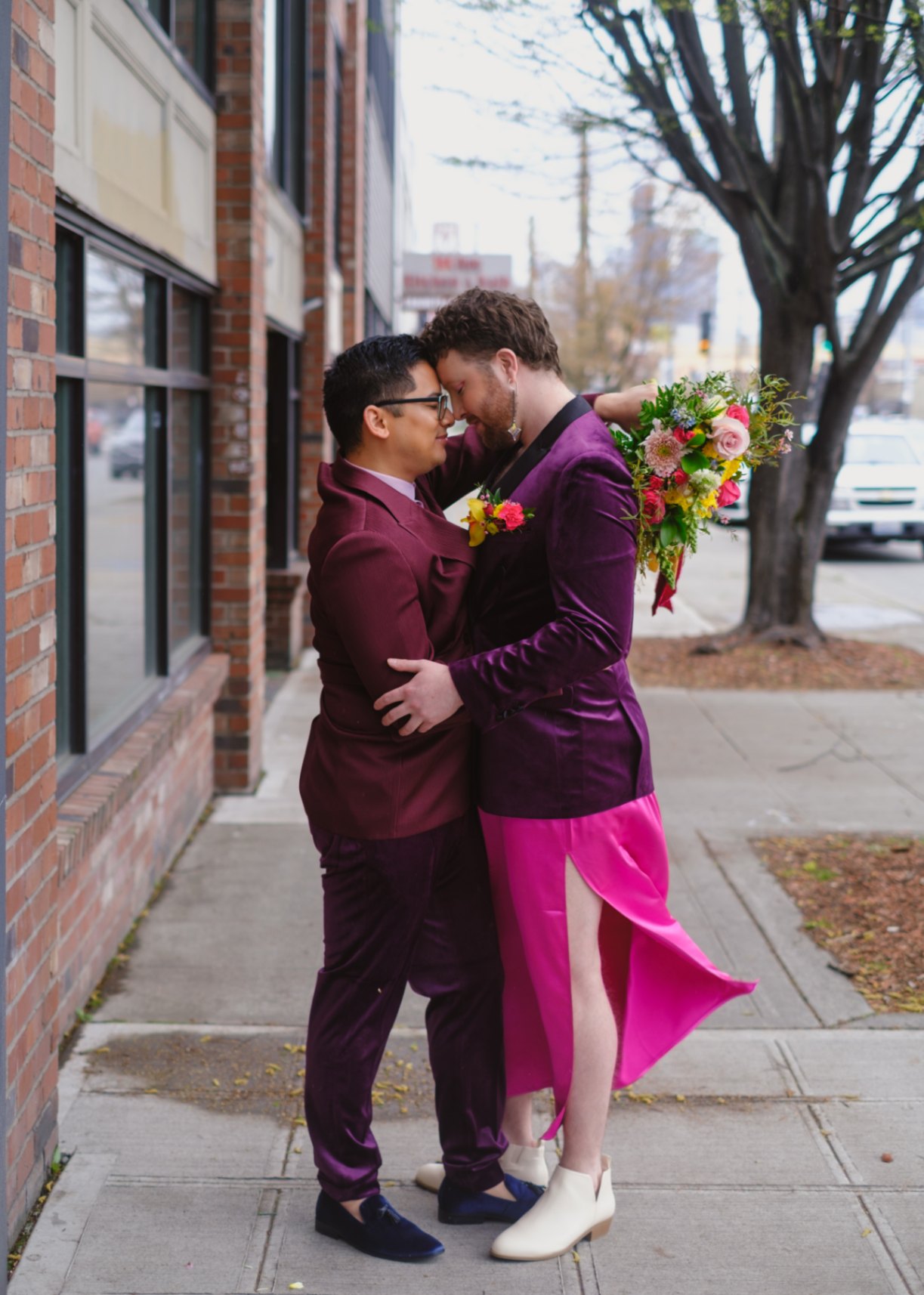 Nonbinary queer couple embrace on the street