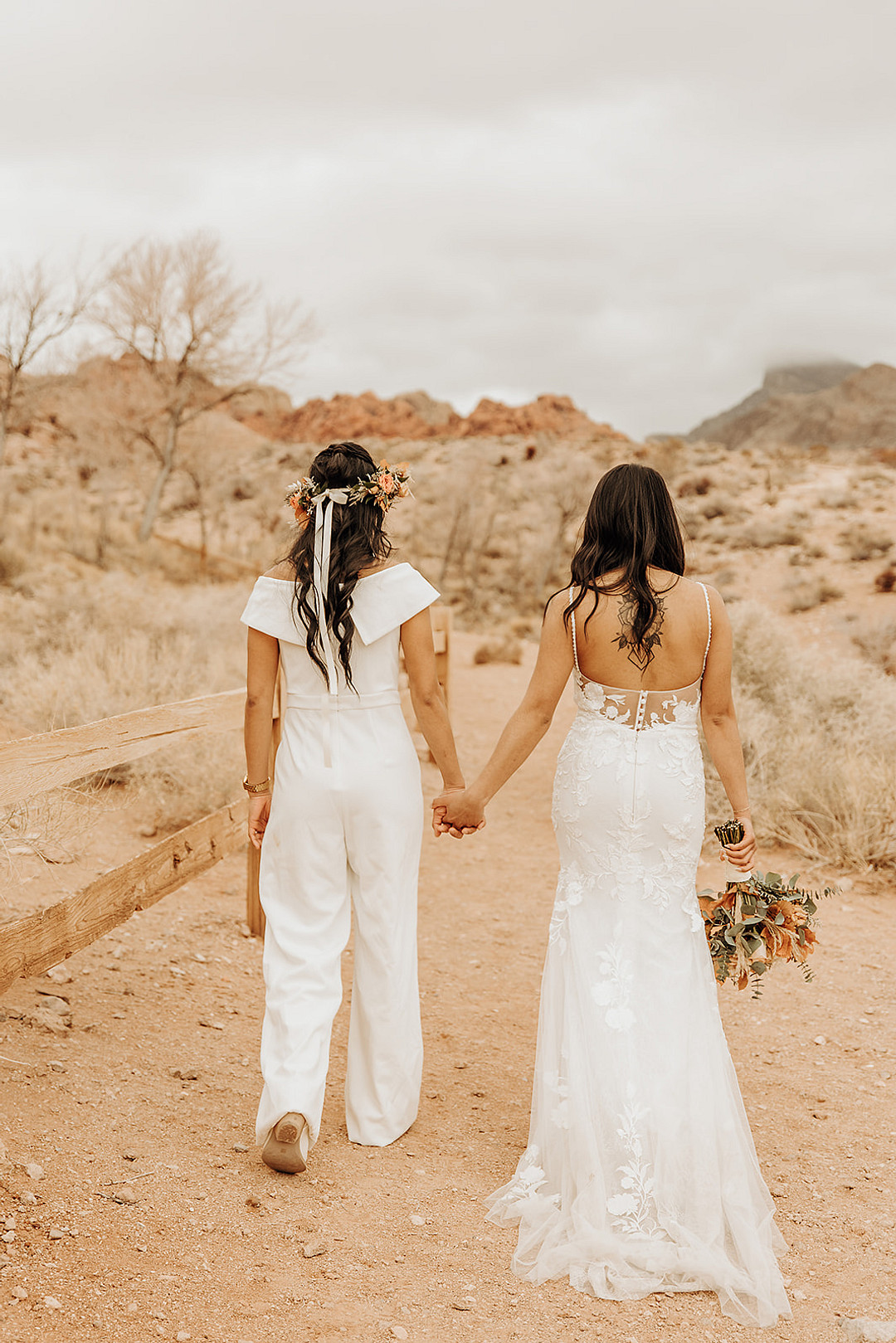 Lesbian brides hold hands in Red Rock Canyon State Park.