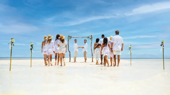Key West wedding on the beach with two grooms and guests dressed in white