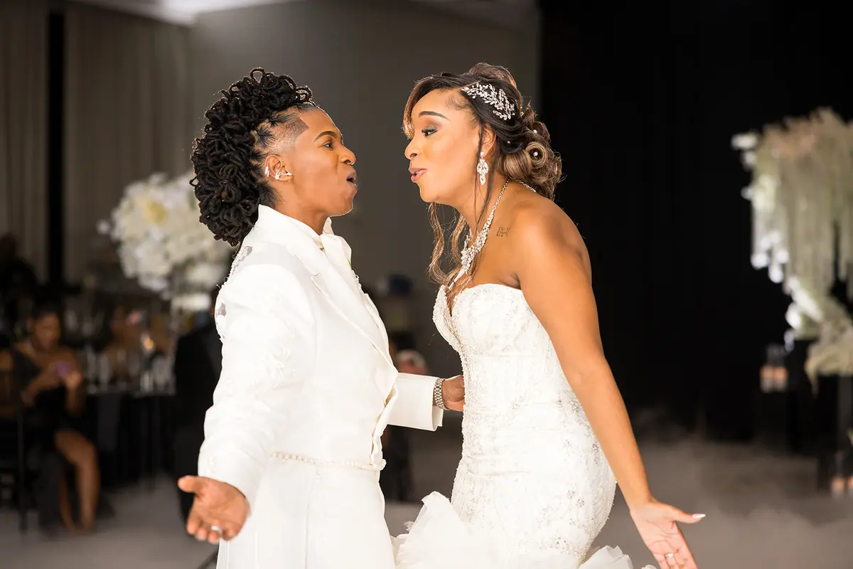 Two Black brides dancing playfully together at Atlanta LGBTQ wedding reception