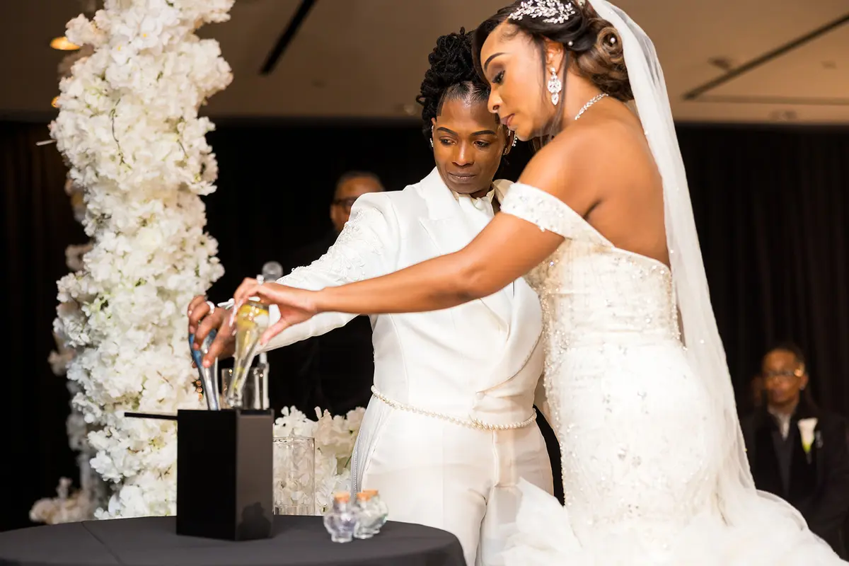 Two Black brides performing sand ceremony together at Atlanta LGBTQ wedding