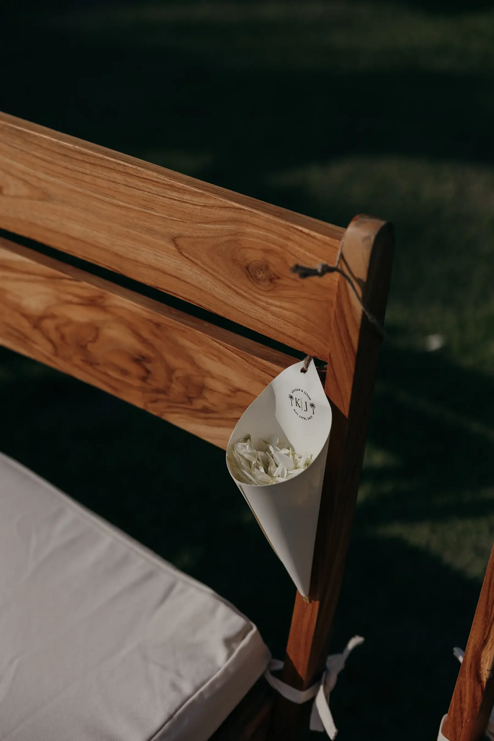 Small paper cups with flower petals tied to ceremony chairs for guest toss at Four Seasons Tamarindo wedding in Mexico