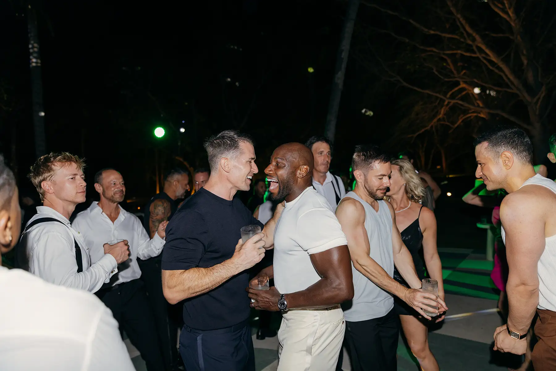 Wedding guests dancing at evening reception with two DJs at Four Seasons Tamarindo destination wedding in Mexico