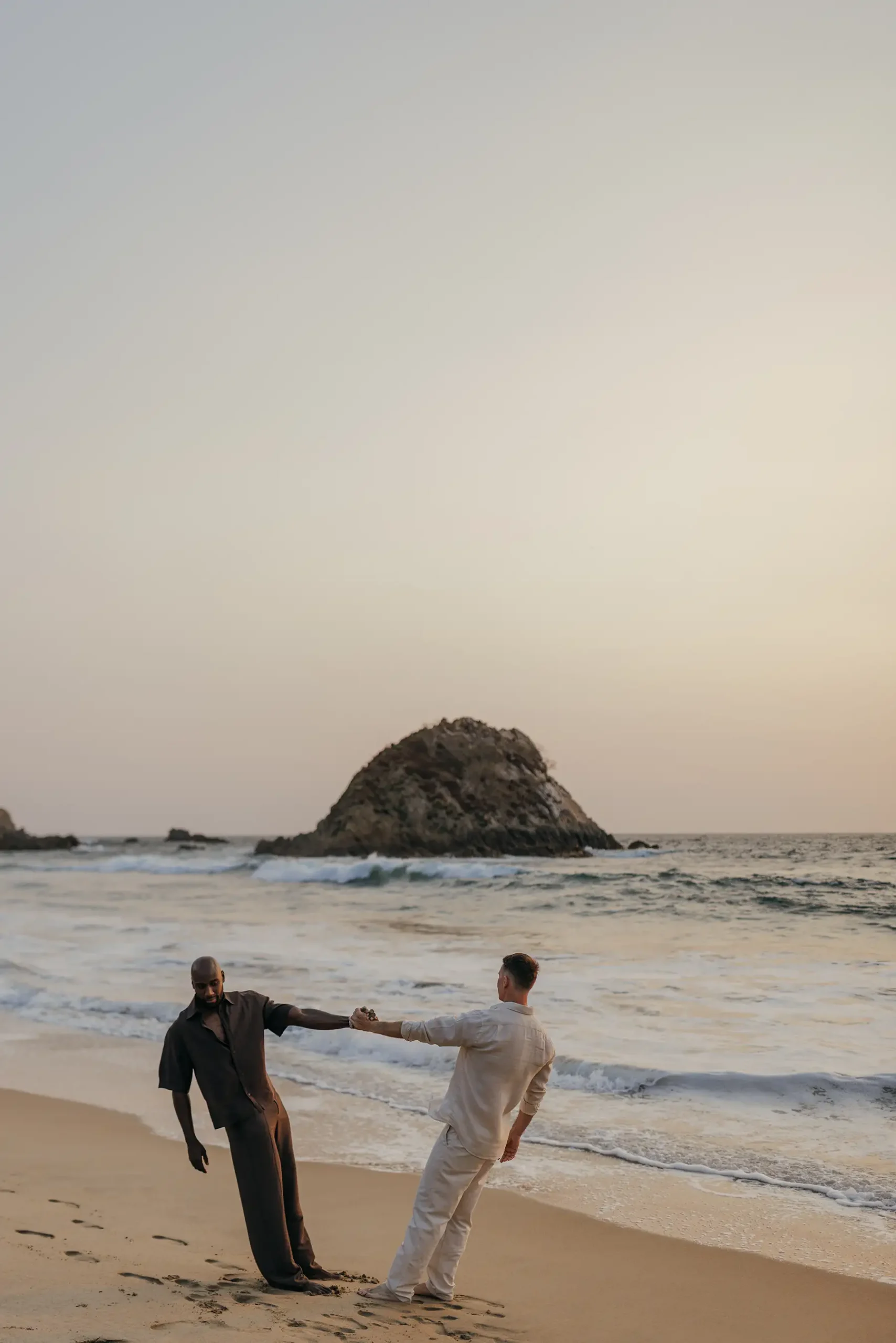 Khasan Brailsford and Jason Silverman in casual clothing for relaxed portraits at Four Seasons Tamarindo during wedding weekend